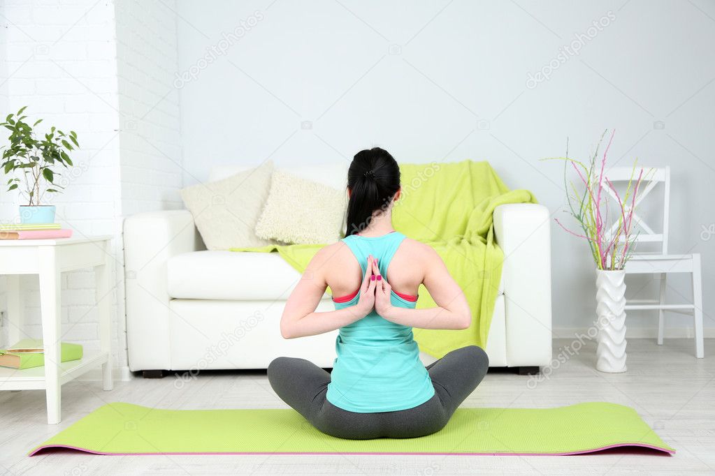 Young woman doing yoga at home