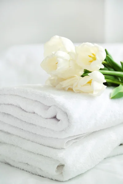 Vita vackra tulpaner på nya handdukar i hotellet, på nära håll — Stockfoto