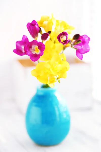 Colorful beautiful freesias on wooden windowsill — Stock Photo, Image