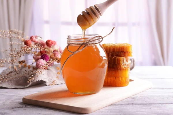 Delicioso mel na mesa no fundo claro — Fotografia de Stock