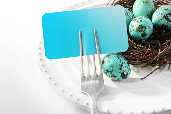 Easter table setting with empty card and Easter eggs, isolated on white — Stock Photo, Image