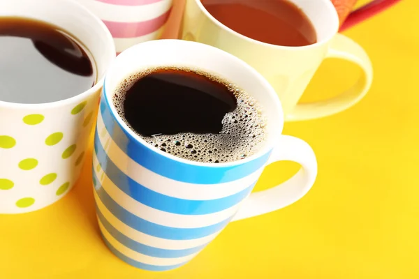 Many cups of coffee on color table, closeup — Stock Photo, Image