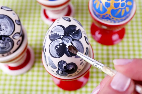 Young woman painting Easter eggs on table close up — Stock Photo, Image