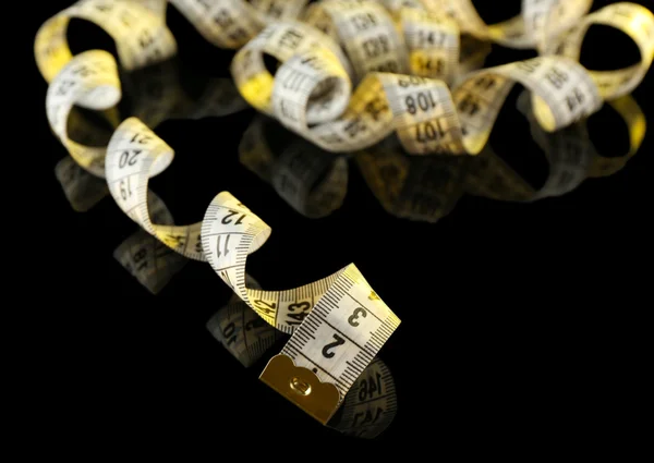 Measuring tape on black background — Stock Photo, Image