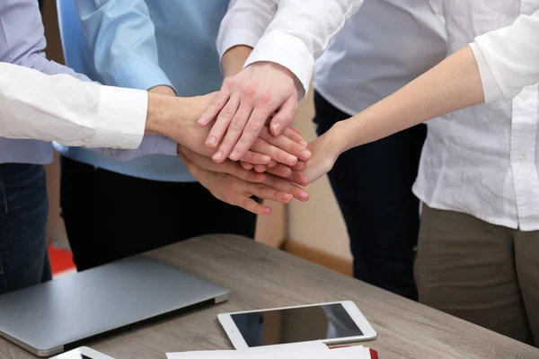 United hands of business team on workspace background — Stock Photo, Image