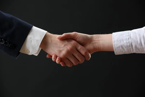 Business handshake on dark background — Stock Photo, Image