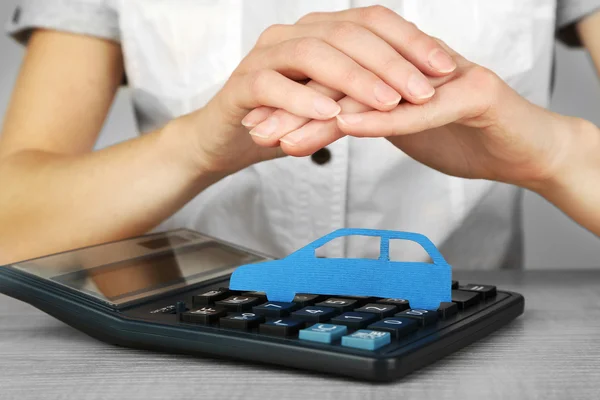 Hands and toy car. Protection of car concept