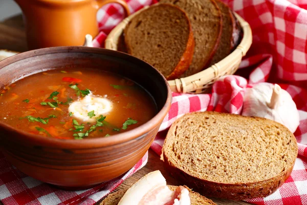 Ukrainian beetroot soup - borscht, on napkin, on wooden background — Stock Photo, Image
