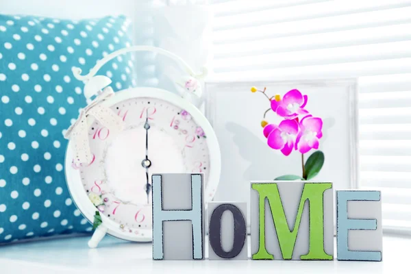 Home in colorful letters in light white interior — Stock Photo, Image