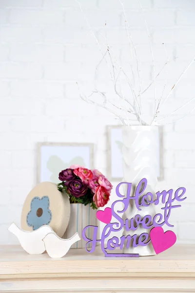 Home in colorful letters, in light white interior, on wooden shelf — Stock Photo, Image