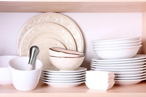 Kitchen utensils and tableware on shelf — Stock Photo, Image