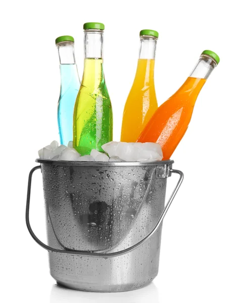 Bottles of tasty drink in metal bucket with ice isolated on white — Stock Photo, Image