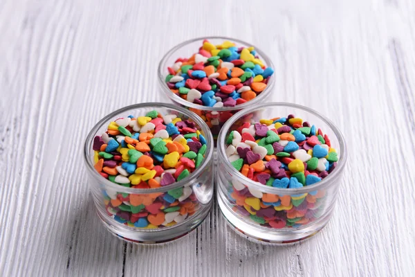 Colorful sprinkles in bowls on table close-up — Stock Photo, Image