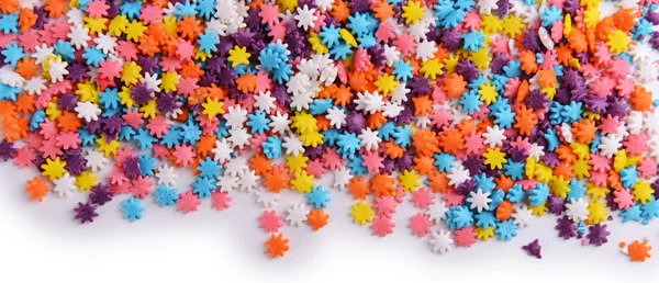 Colorful sprinkles on white background — Stock Photo, Image