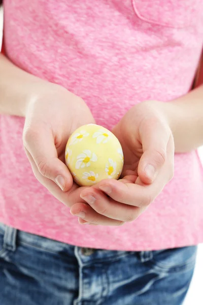 Girl holding painted egg in her hands, close-up — Stock Photo, Image