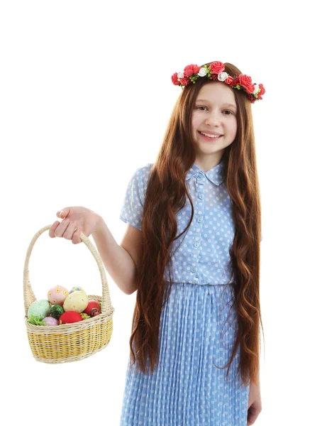 Beautiful little girl holding wicker basket with Easter eggs, isolated on white — Stock Photo, Image