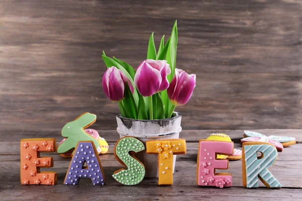 Delicious Easter cookies on table on wooden background — Stock Photo, Image