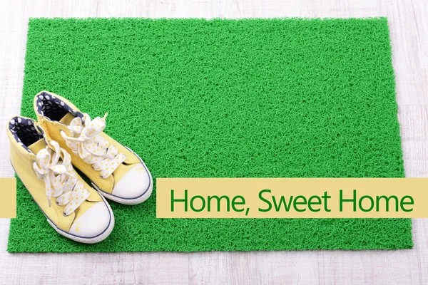 Green carpet on floor and converse close-up — Stock Photo, Image