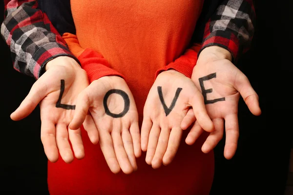 Hands of couple with inscription Love, close-up — Stock Photo, Image