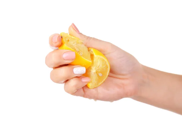 Vrouwelijke hand knijpen citroen geïsoleerd op wit — Stockfoto