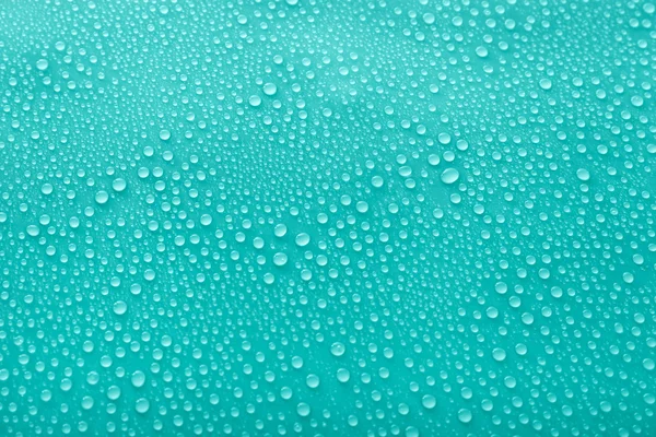 Water drops on glass on green background — Stock Photo, Image