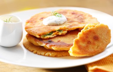 Mısır ekmeği ile doldurma ve bardak suyu ahşap masa arka plan üzerinde yığını