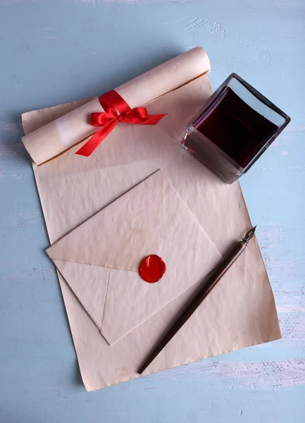 Envelope com caneta e tinta sobre fundo de madeira — Fotografia de Stock