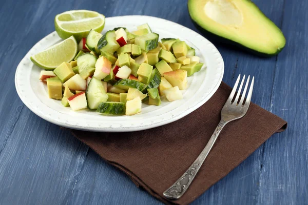 Salad with apple and avocado in bowl on table close up — Stock Photo, Image