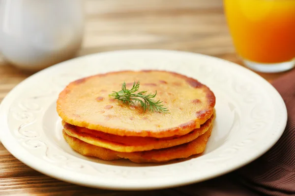 Stack of corn tortillas with stuffing and glass of juice on wooden table background — Stock Photo, Image