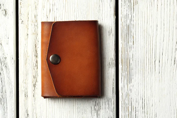 Hand made leather man wallet on white wooden background — Stock Photo, Image