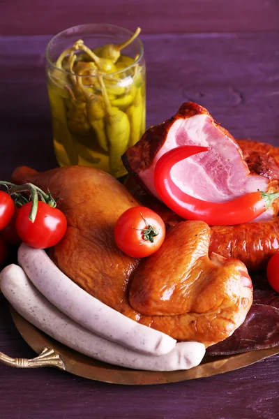 Assortment of deli meats on metal tray on color wooden background — Stock Photo, Image