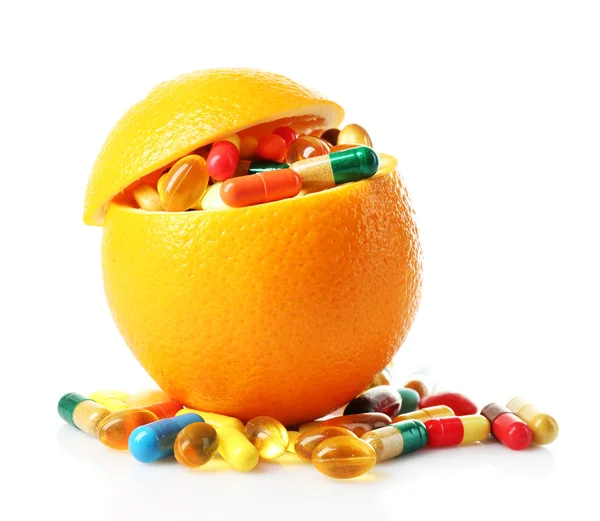 Orange fruit and colorful pills, isolated on white — Stock Photo, Image