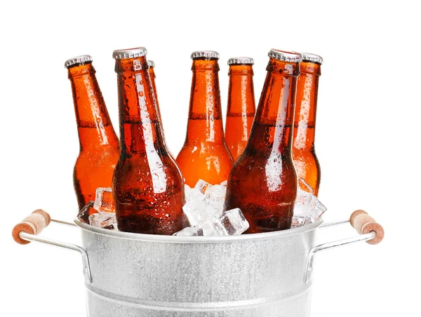 Glass bottles of beer in metal bucket isolated on white — Stock Photo, Image
