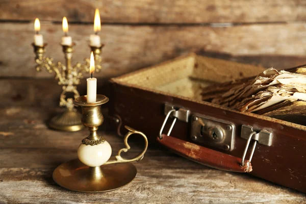 Old wooden suitcase with old books on wooden background — Stock Photo, Image