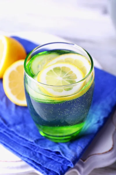 Fresh water with lemon and cucumber in glassware on wooden table, closeup — Stock Photo, Image