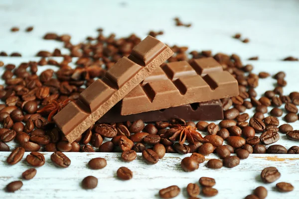 Chocolate with star anise and coffee beans on wooden background — Stock Photo, Image