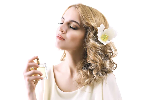 Hermosa joven con botella de perfume aislado en blanco — Foto de Stock