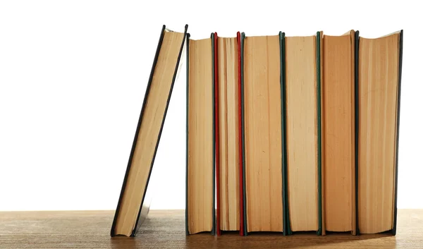 Old books on wooden table isolated on white — Stock Photo, Image