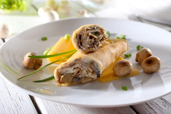 Pancakes with cream and mushrooms on wooden table, closeup — Stock Photo, Image