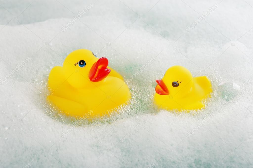 Rubber ducks in foam close-up