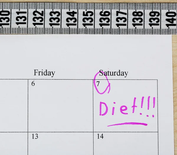 Diet concept - measure tape on calendar, close up — Stock Photo, Image