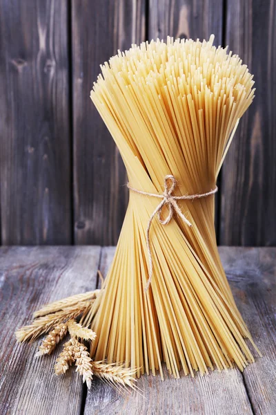 Pasta with ears on wooden background — Stock Photo, Image