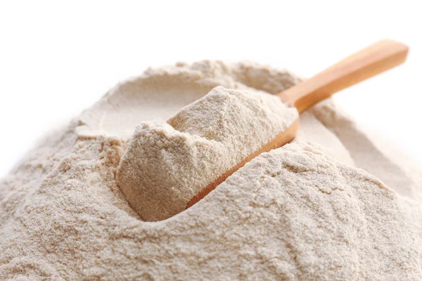 Heap of flour with wooden spoon isolated on white — Stock Photo, Image