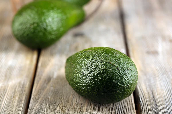 Avocado on wooden background — Stock Photo, Image