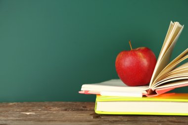 Kitap, apple ve tebeşir yazı tahtası arka plan üzerinde