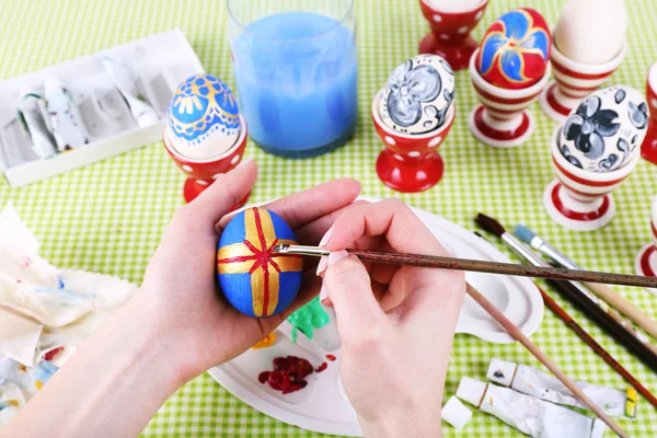 Young woman painting Easter eggs on table close up — Stock Photo, Image