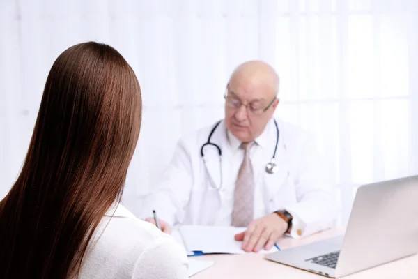 Médecin professionnel recevant le patient dans son bureau sur fond de rideau blanc — Photo