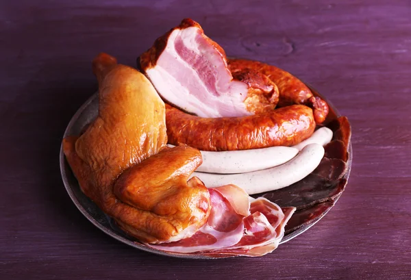 Assortment of deli meats on metal tray on color wooden background — Stock Photo, Image