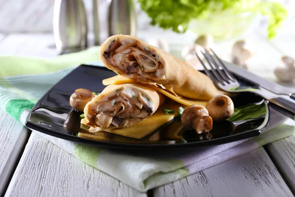 Pancakes with cream and mushrooms on wooden table, closeup — Stock Photo, Image