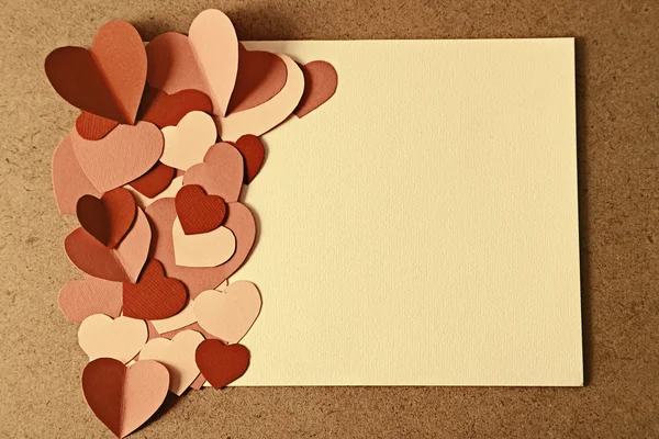 Beautiful hand made post card  with paper hearts on color wooden background — Stock Photo, Image